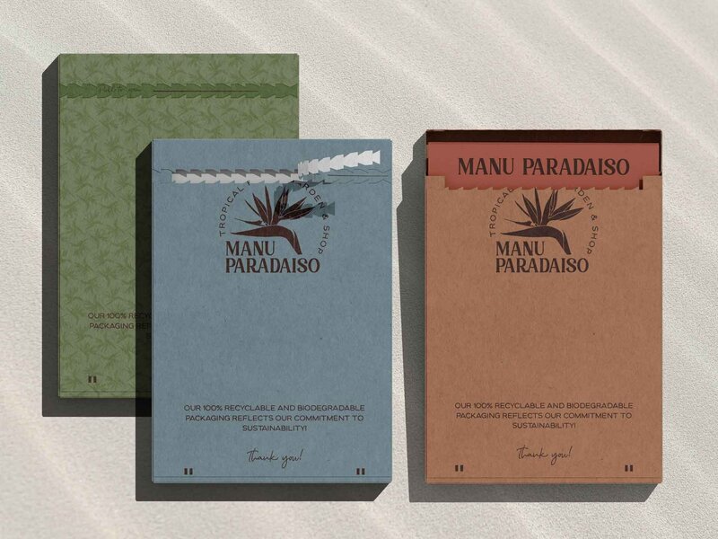 Three letter sized boxes branded for 'Manu Paradiso' alternating colors of red, blue, and green.