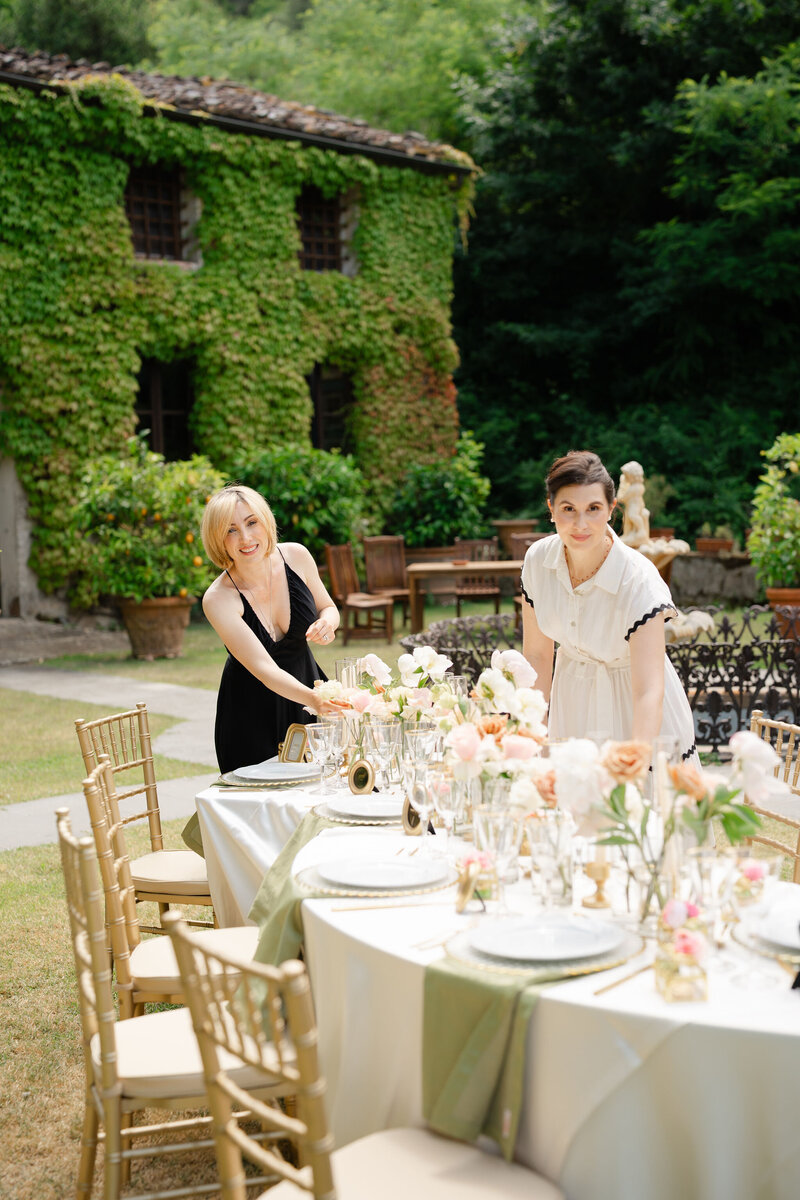 Luxury destination wedding planners checking on the table settings