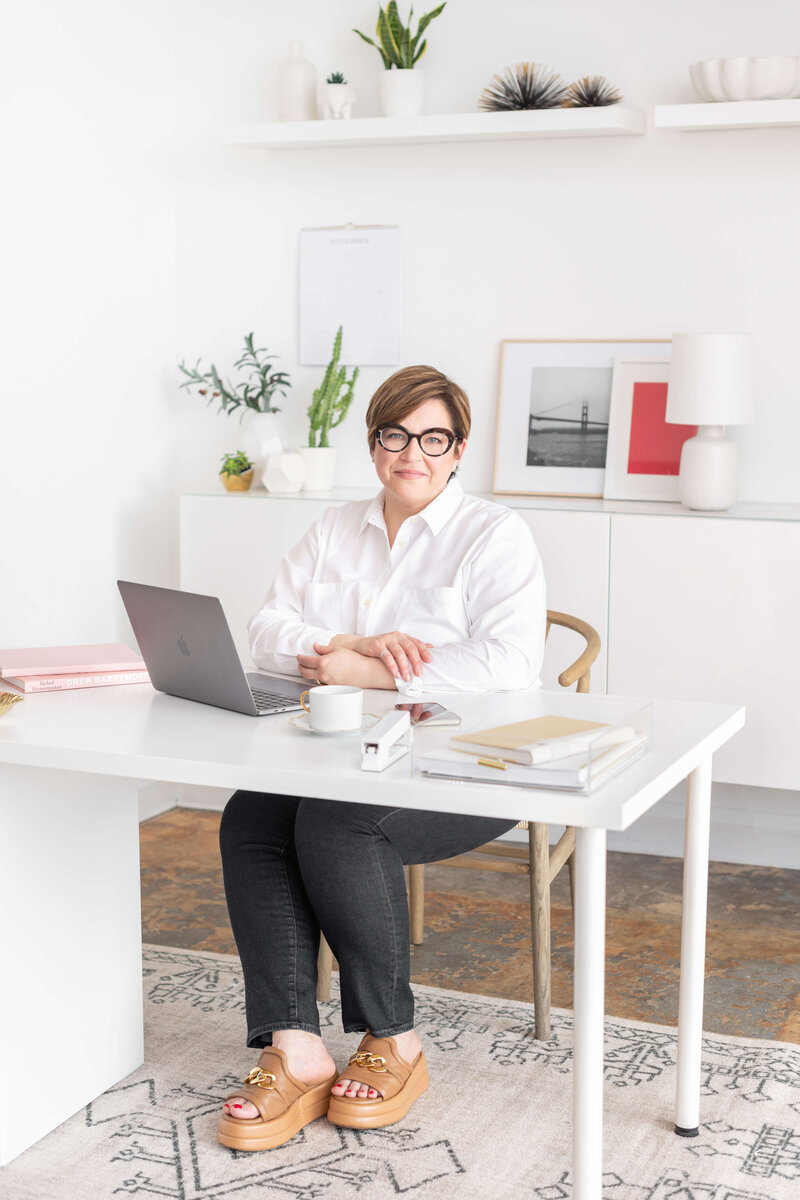 Elegant middle aged woman in white shirt in modernoffice