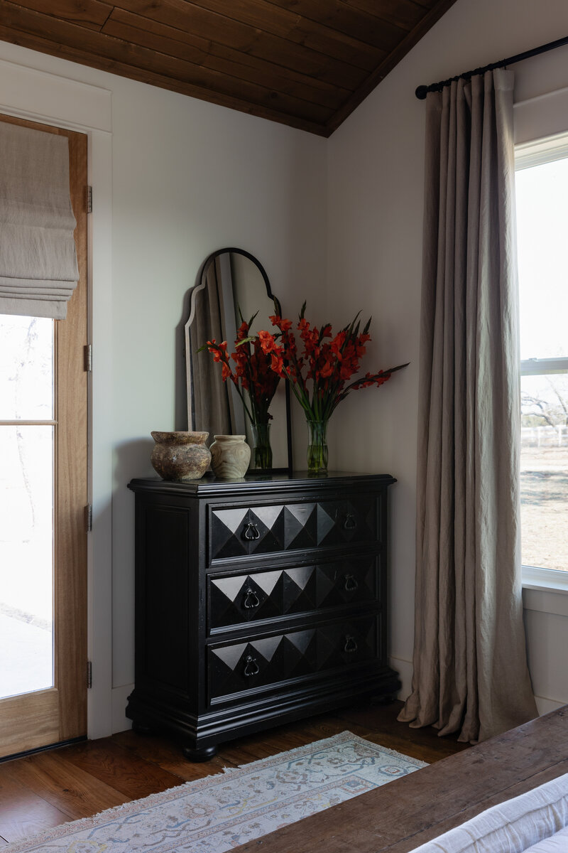 A vignette moment in a European inspired farmhouse bedroom in the Texas Hill Country by Jessa Myer Interiors.