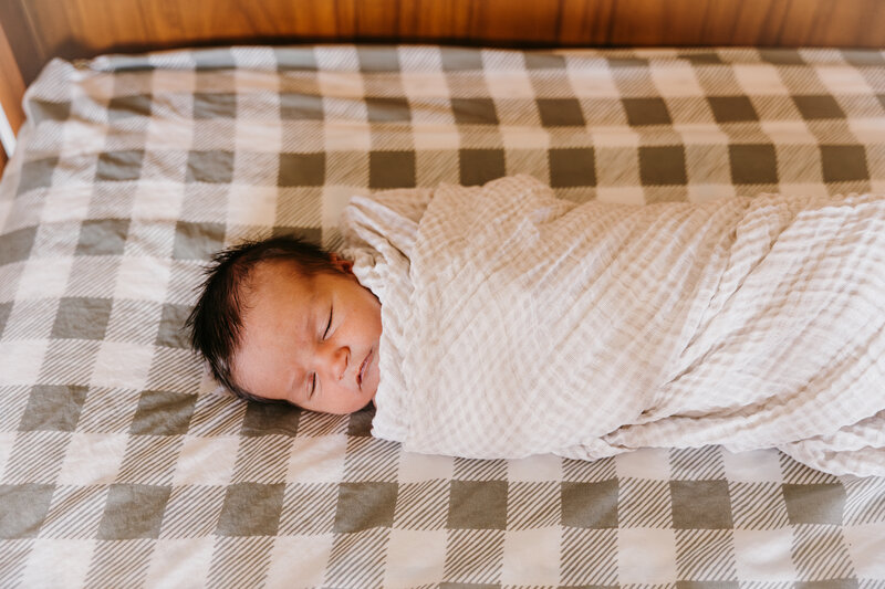 newbron laying in crib 