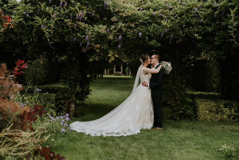 Wedding couple kissing in garden