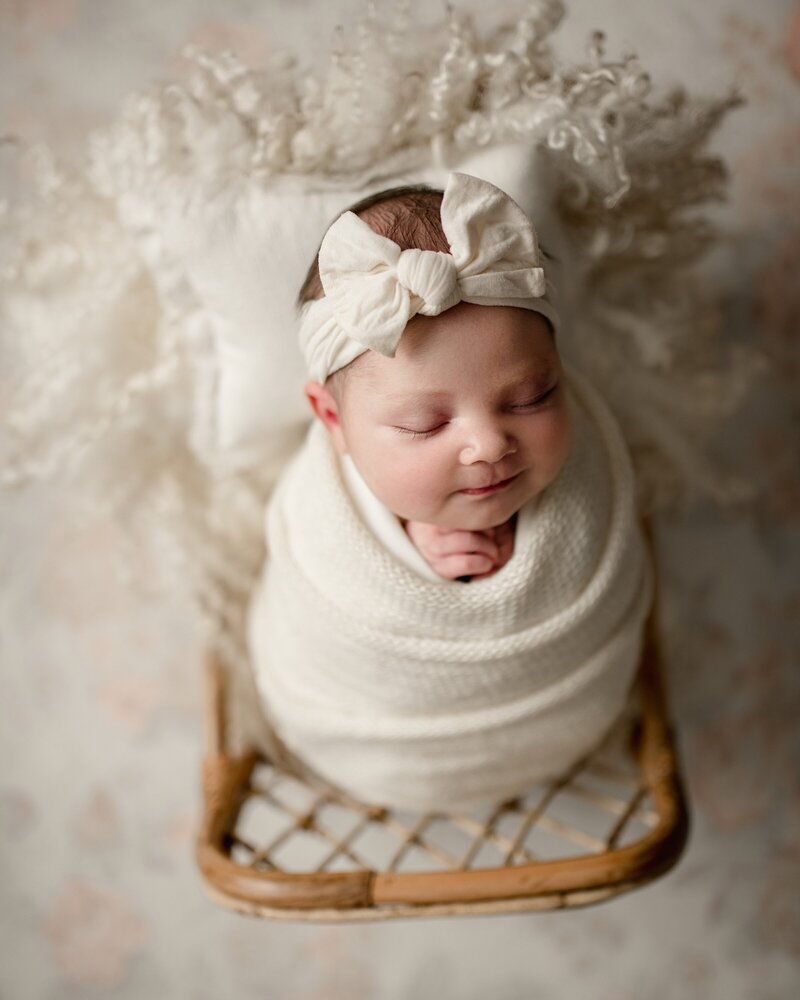 smiling-newborn-girl-in-crib