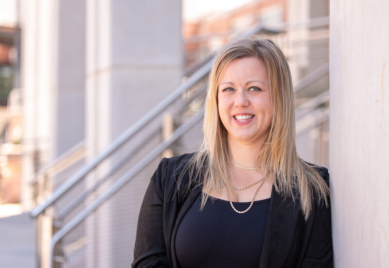 Attorney Erin K. Urquhart of McDow & Urquhart LLC standing outside the Rock Hill, SC courthouse, smiling in a professional portrait.