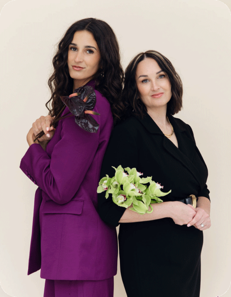 image of two women standing back to back 