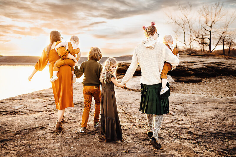 Bowling Green, Kentucky Family photographer.  Family at barren river lake walking hand and hand at sunset.