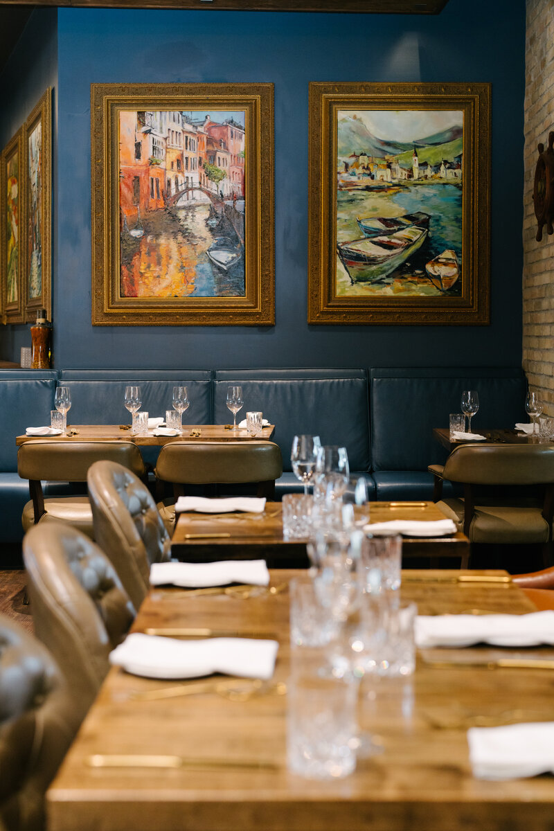 Interior of Trattoria Timone, high end italic restaurant with rich blue walls and bench seats