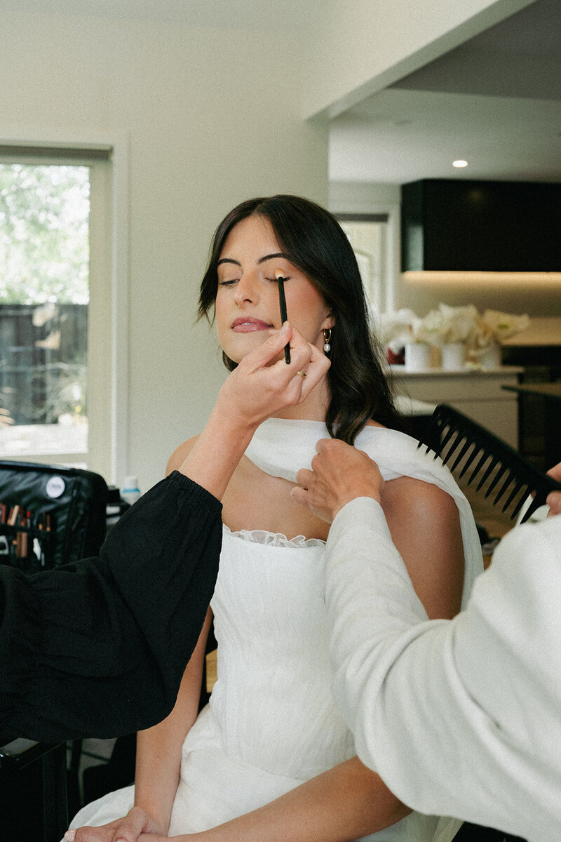 paige shipstone with makeup for bride on wedding day in queenstown