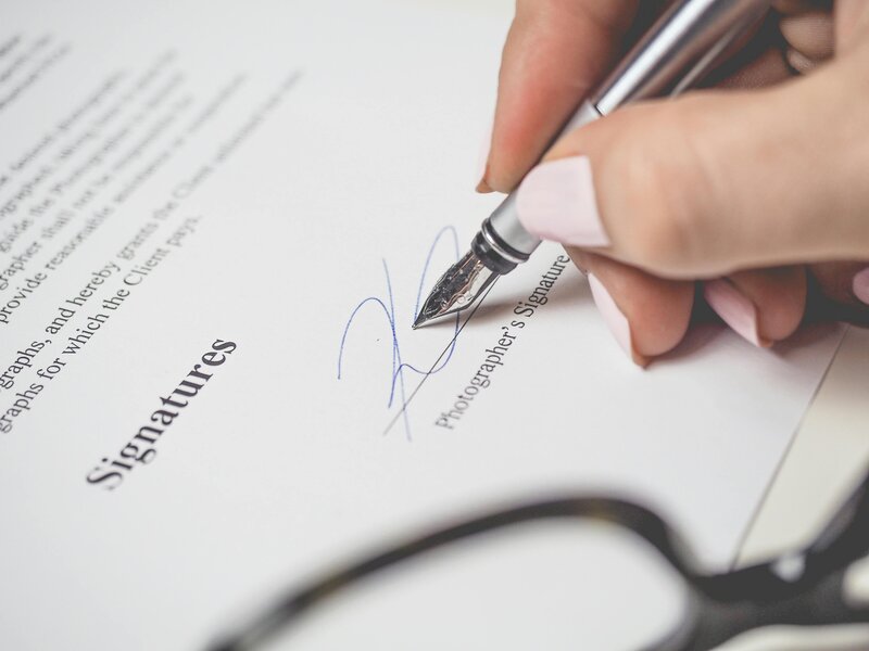 person signing a contract