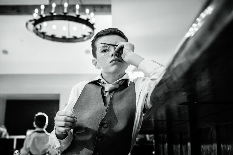 A child with a bubble in front of his eye during a wedding reception at Spruce Peak in Stowe, Vermont, captured by Eaton Photo