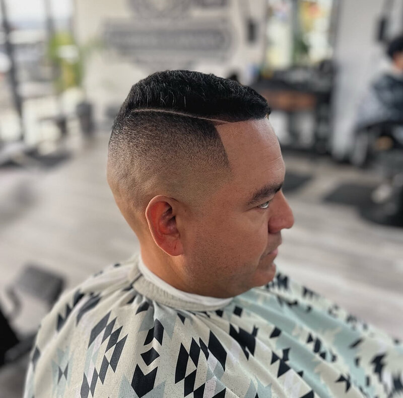 A finished haircut with a hard part at Onyx Barbershop in Wildomar, CA.