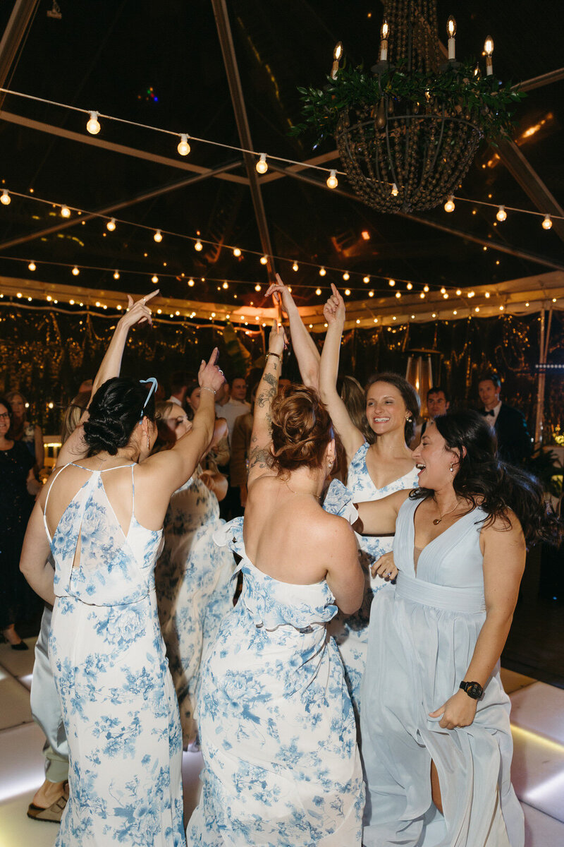 Bridesmaids dancing on a wedding dancing floor at the reception, by Andrea-Marie Photography