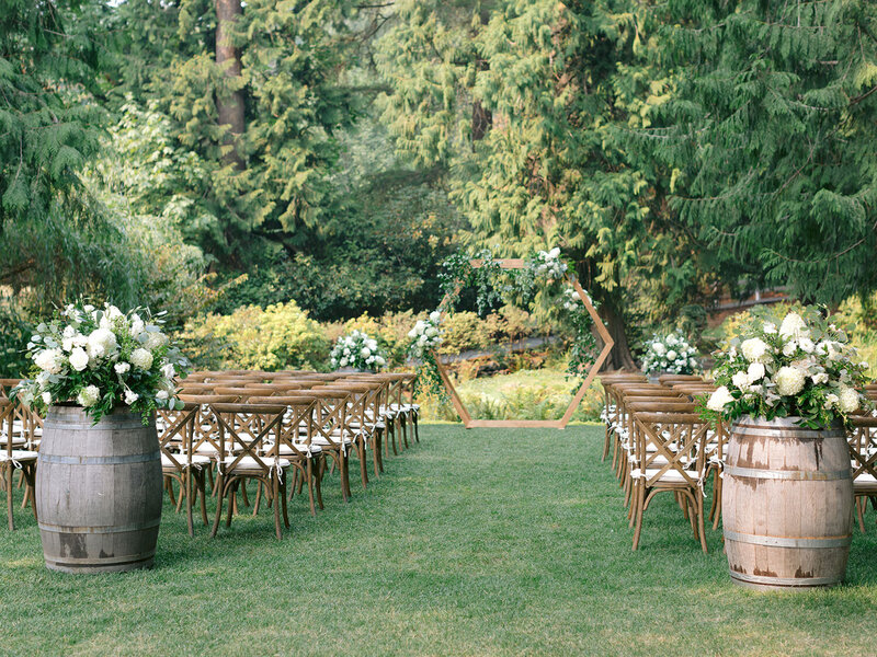 Wooden chairs arranged for an outdoor ceremony
