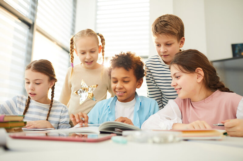 students in library reading books