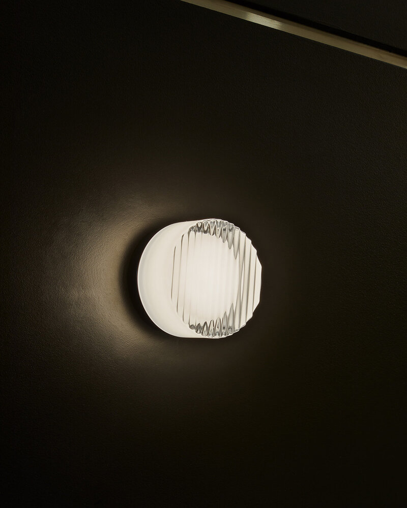 A bright circular light boldly set over a dark background