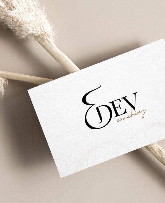e dev coaching branding on a business card with neutral background