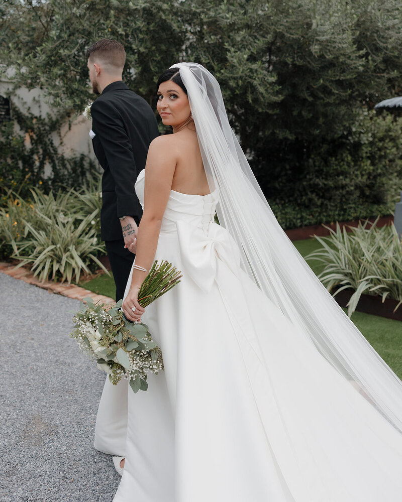 bride and groom walk into wedding venue