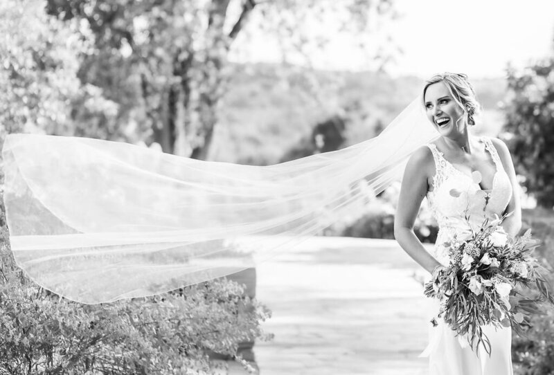 Laughing bride as her veil blows in the wind, Hayfields Country Club wedding, Maryland