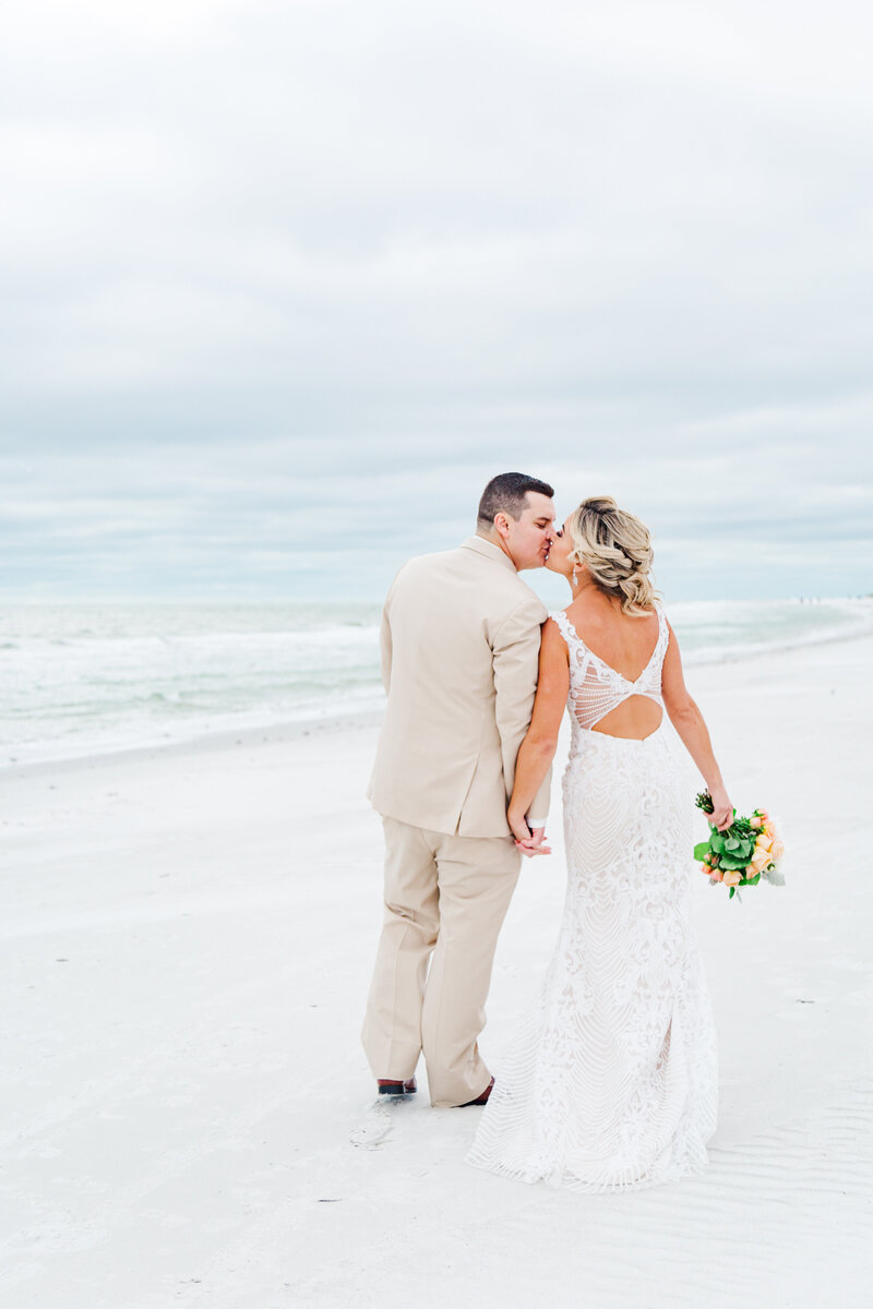 Bride and groom share kiss on St Pete Beach at their wedding