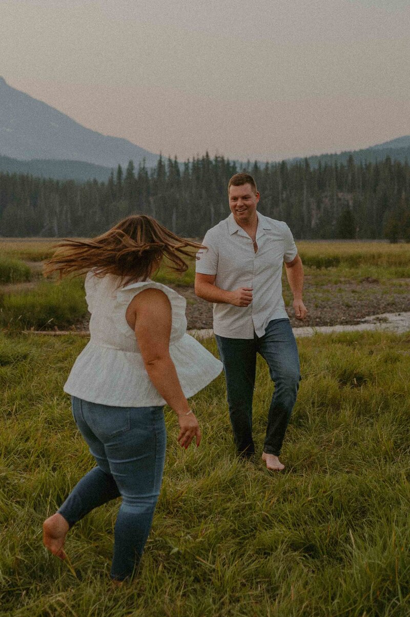 Couple chasing each other through a meadow near Sparks lake