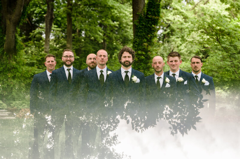 Groomsmen standin front of trees