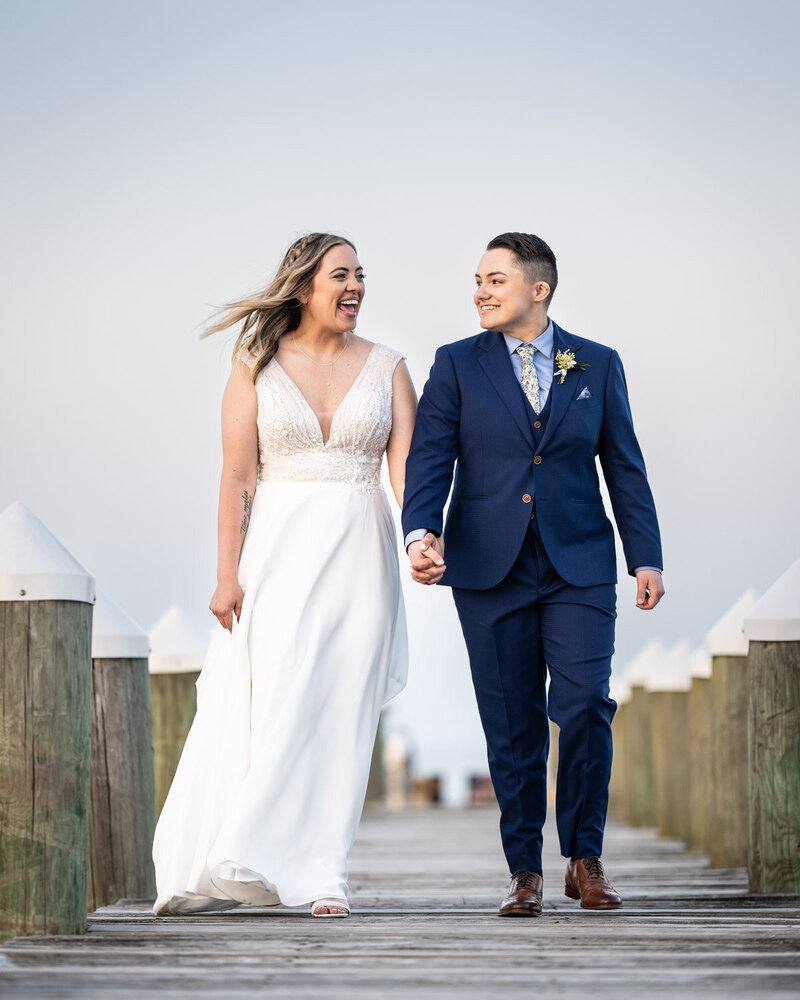 Couple walking along dock at Bay Waveland Yacht Club