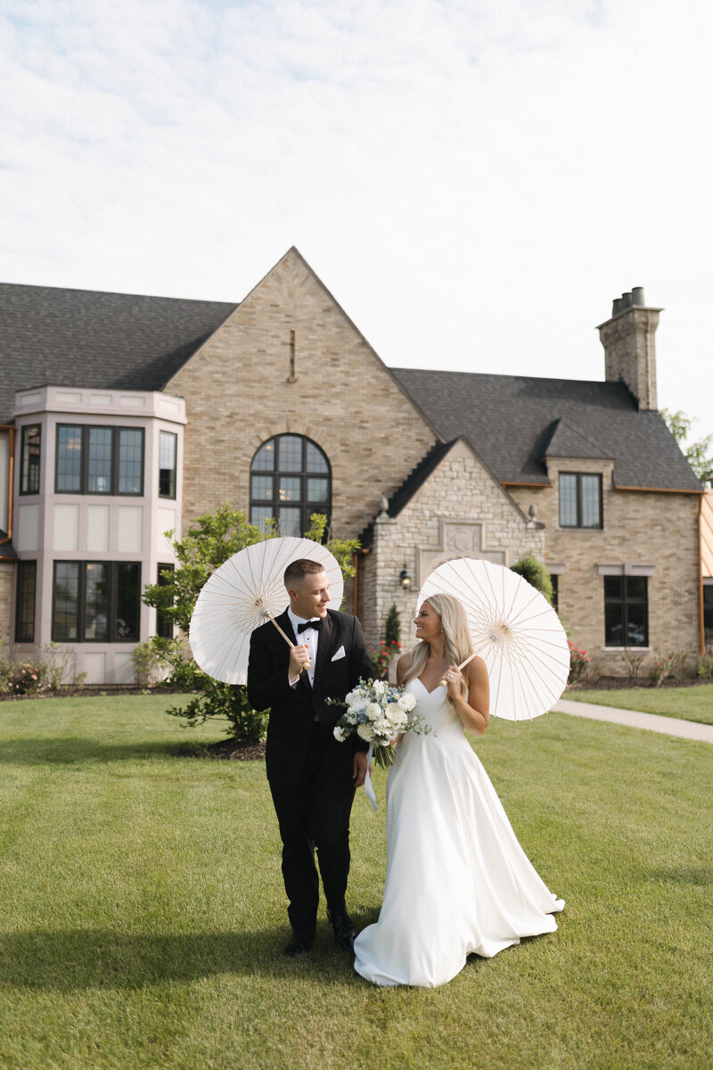bride and groom sunset portrait with parasols 