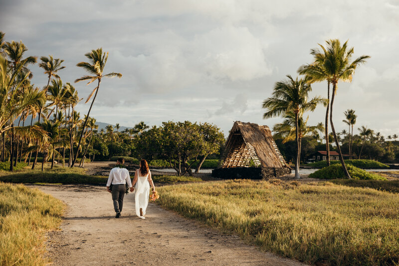 Bride and groom choose to elope in maui and book maui elopement packages, later walking hand in hand on beach