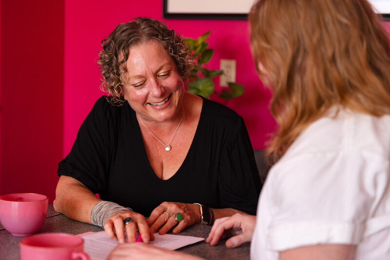 Oregon business lawyer Cassie smiles while helping a client in her Eugene Oregon law office.