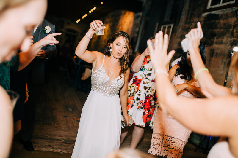 Bride dancing with a drink