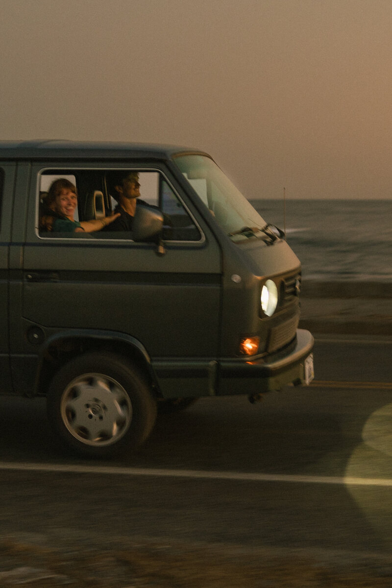 Couple driving along Ocean Drive in Newport, RI