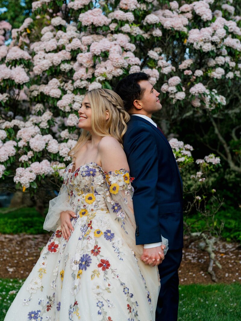 bride and groom looking out in distance at golden hour
