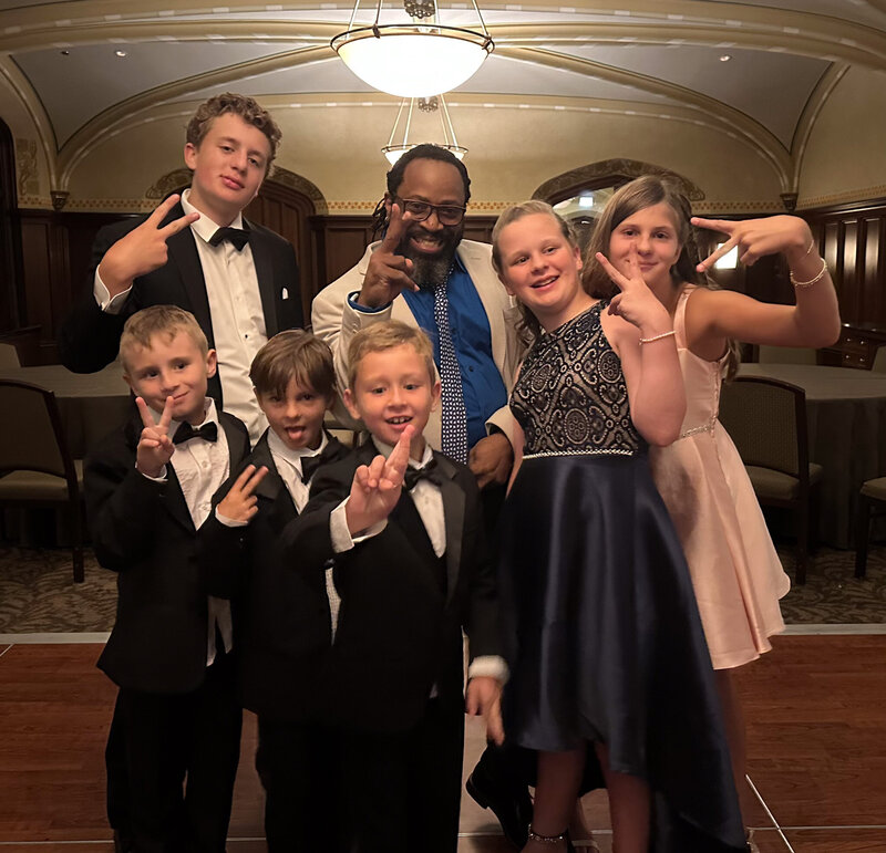 DJ and kids striking fun poses together