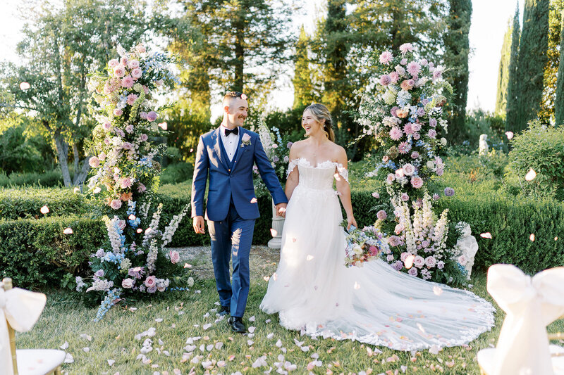 Wedding party dressed in elegant and colorful pastels sits for an editorial bo inspired photo during a wedding in Napa Valley