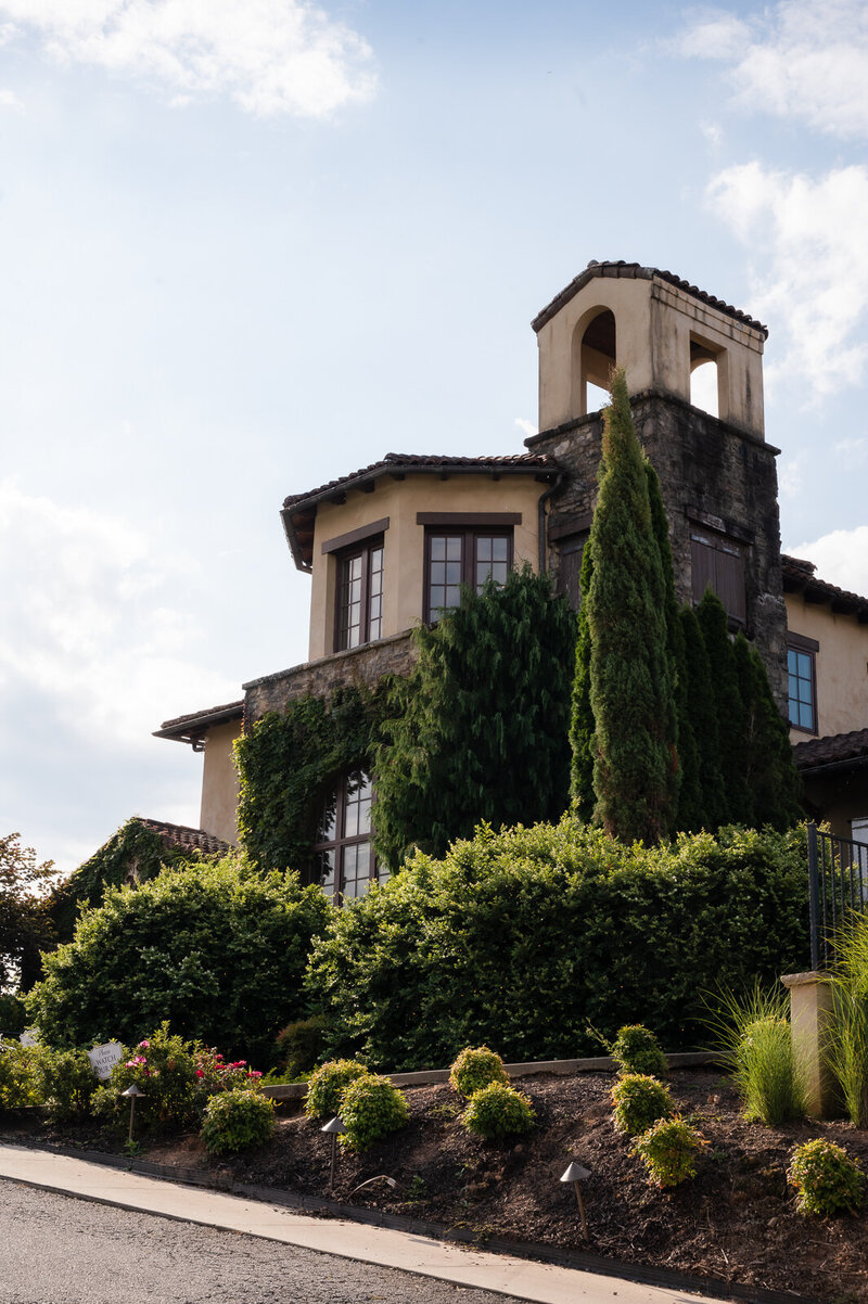 A tan building with greenery at Montaluce Winery in Dahlonega, GA