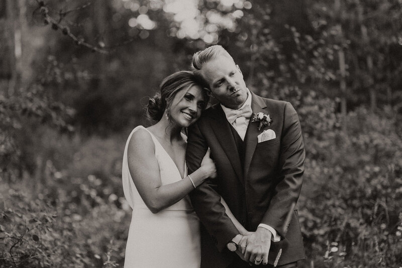 Alana and Ryan standing together on their wedding day, in a black and white photo