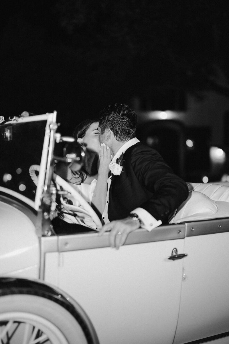 bride and groom in the getaway car photographed by Julie & Daniel