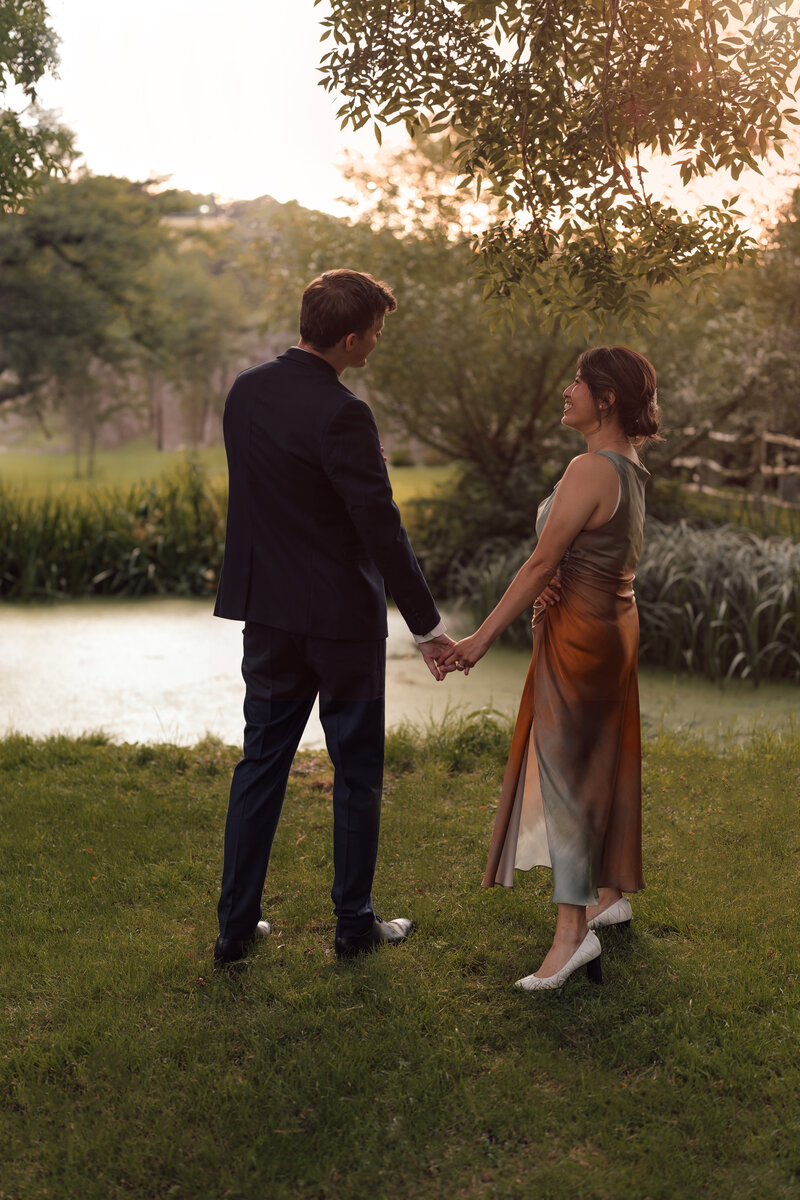 Wedding photographer captures couple taking a stroll hand in hand at their french chateau wedding.