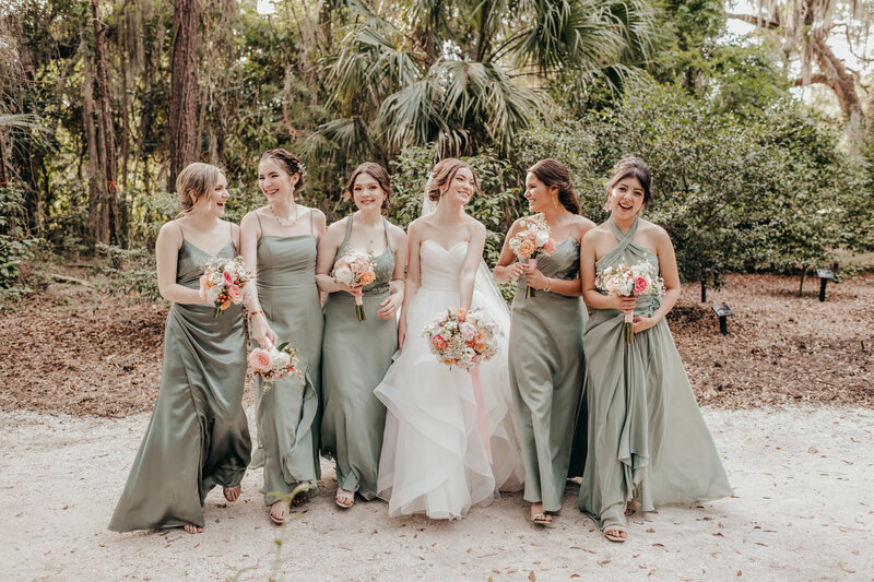 bride with bridesmaid in sage green dresses at hilton head wedding
