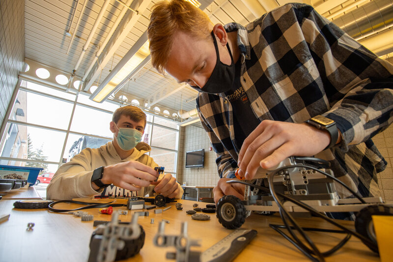 020821 Engineering 1st year students in pioneer hall building car with masks view from side table view teamwork perspective with parts blurred in bottom third by Madison Thomas