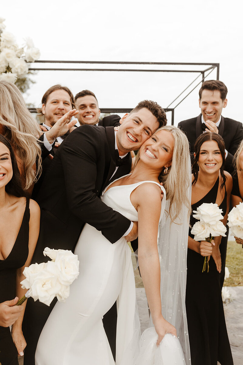 bride and grooms stand together smiling