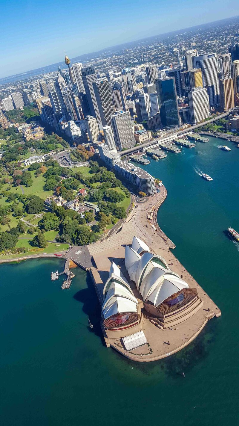 Aerial view of the Sydney Opera House and Circular Quay, with skyscrapers rising behind the harbor ©Stephanie Dosch | theViatrix Australia Private Luxury Travel