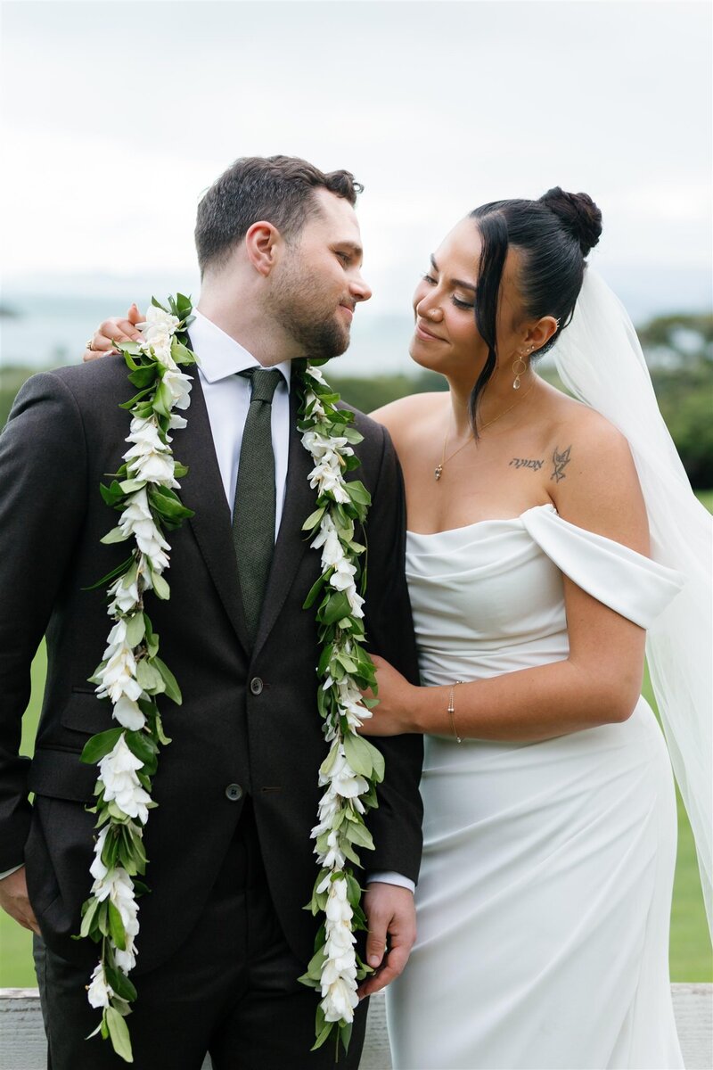 Newlyweds leaning in to each other as they smile together 