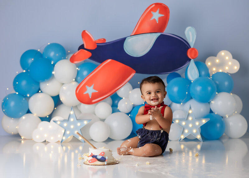 Tampa baby boy enjoying a custom luxury cake smash session with vibrant decorations 