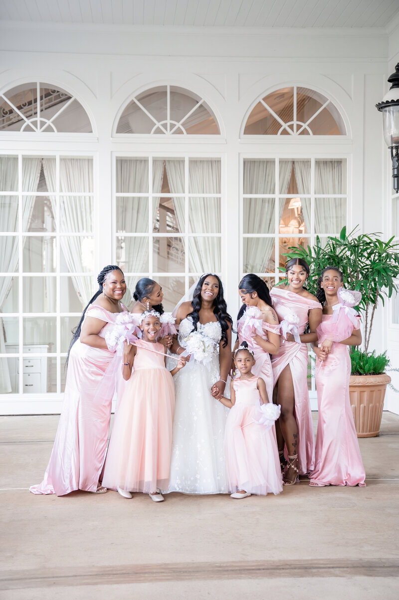 bride with Cinderella's carriage at wedding entrance in Kleinfeld dress