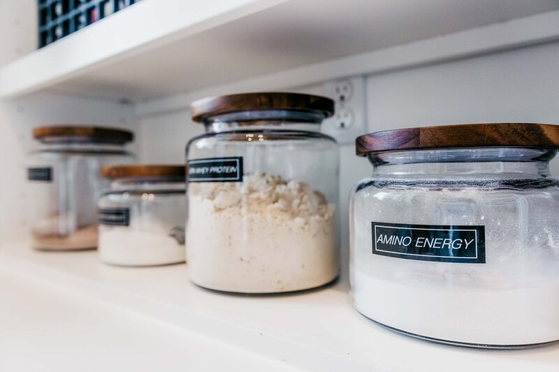 a kitchen pantry shelf showing organized medical poweders