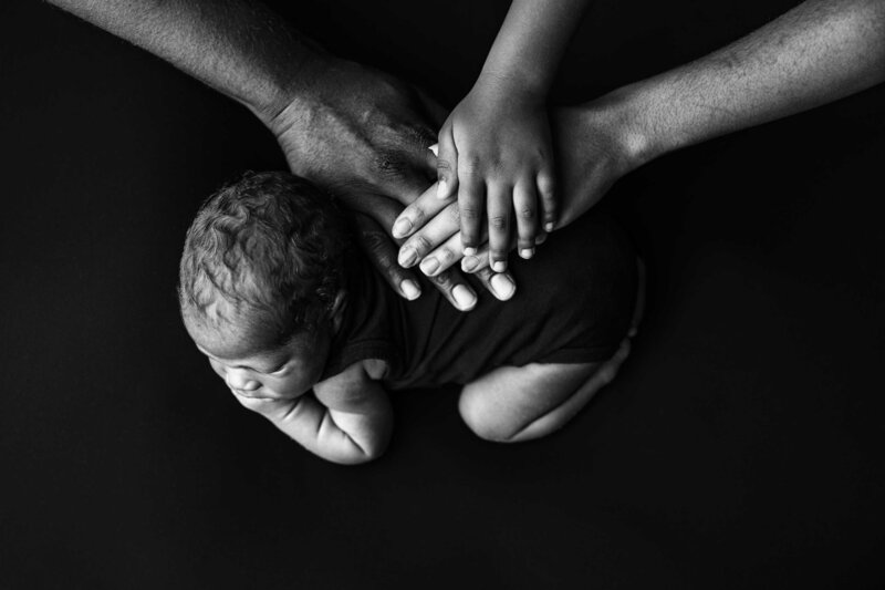 Close up newborn image of baby toes and hands