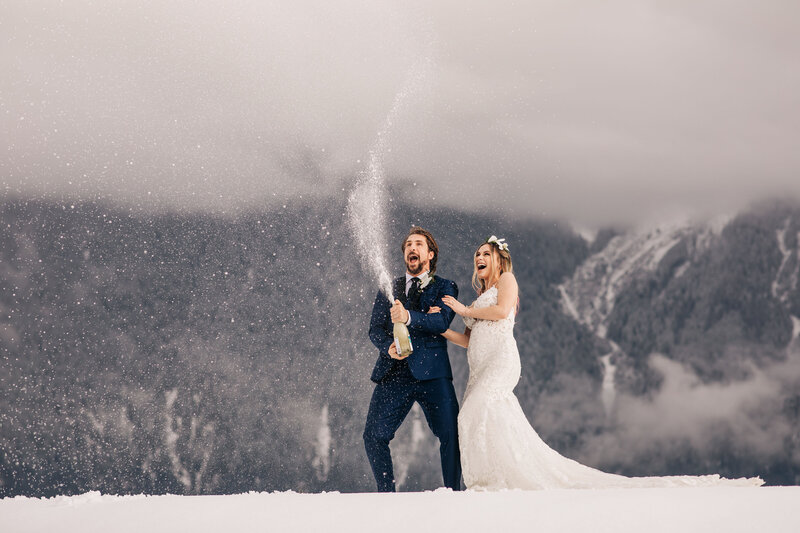 bride and groom embracing in front of moutains