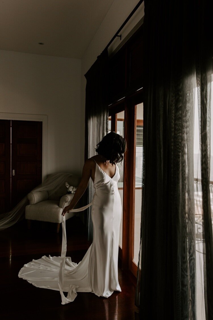 bride-getting-into-kyha-gown-at-villa-vivante.jpg