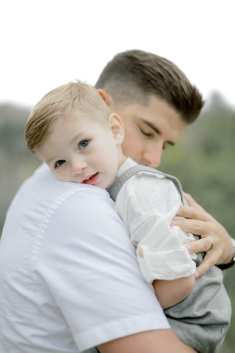 dad holding son with love